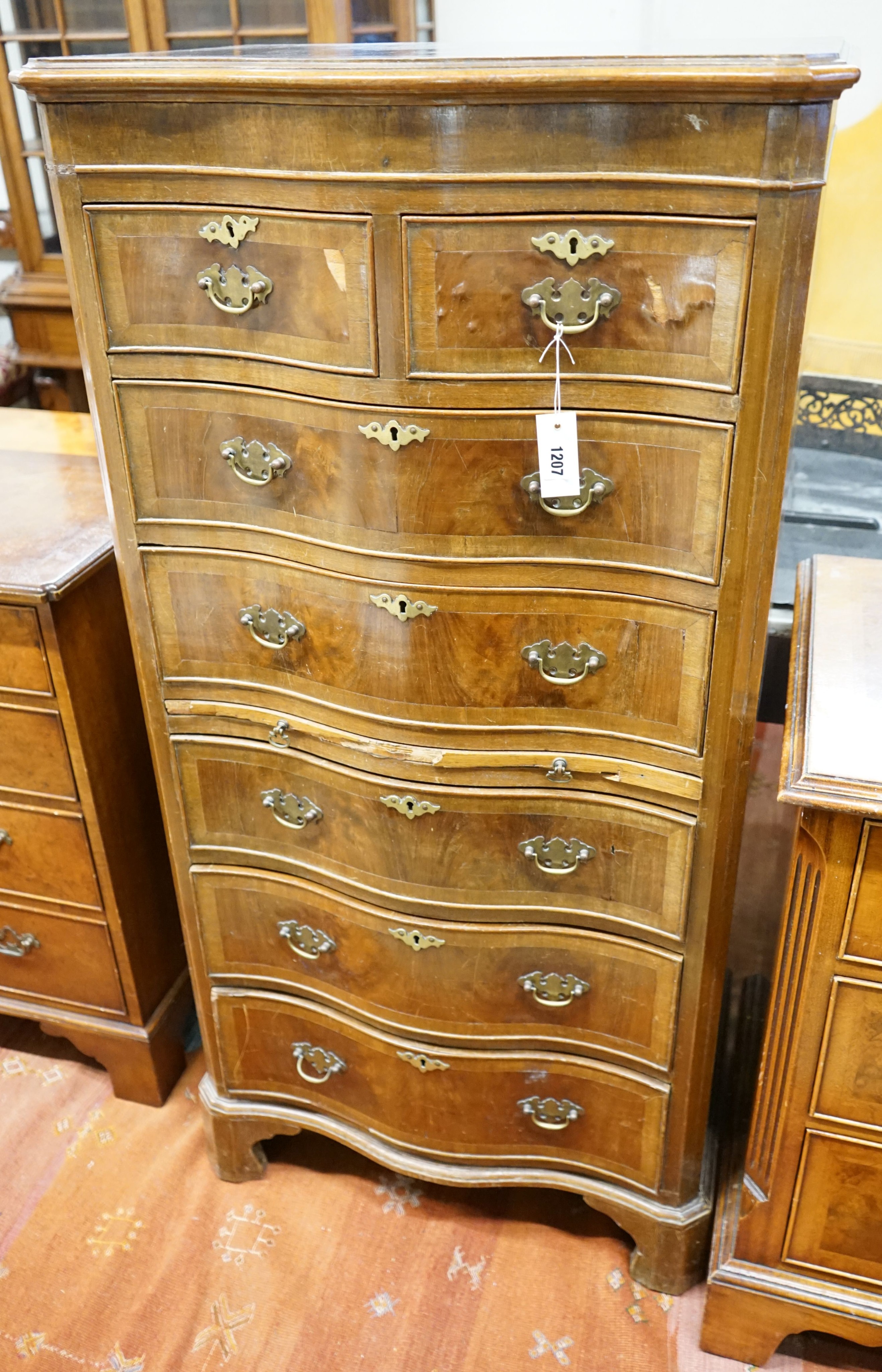 A reproduction 18th century style serpentine walnut tall chest fitted slide, width 66cm, depth 43cm, height 134cm